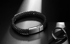 Macro detail of braided black leather strap and brushed stainless steel magnetic clasp