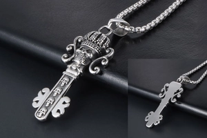 Close-up of gothic crown skull key pendant with vintage silver finish on black leather