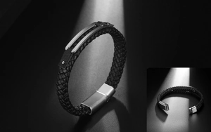 Detailed macro view of woven black leather bracelet with matte steel magnetic clasp