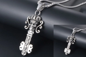 Macro detail of gothic crown skull key pendant on heavy stainless steel chain