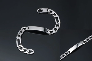 Macro detail of polished titanium steel Figaro chain and customizable rectangle ID plaque