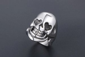 Macro view of polished silver skull ring featuring unique heart-shaped eye sockets