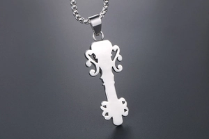 Detail of silver vintage skeleton key pendant with polished box chain for men