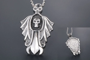 Detailed view of punk skull cloak sword pendant showing intricate back honeycomb texture