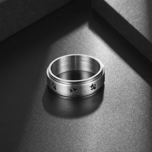 Brushed stainless steel spinner ring featuring engraved sea turtle patterns for stress relief