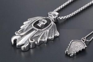 Detail of vintage punk skull wing pendant with honeycomb texture on the back