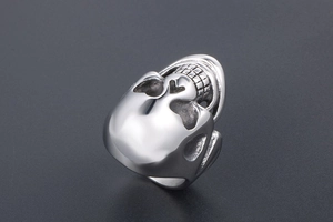 Detailed side view of a polished silver skull ring with vintage punk aesthetic