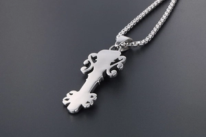 Macro view of vintage skull crown guitar head pendant in polished stainless steel
