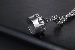 Gros plan détaillé du pendentif couronne vintage en argent sur fond de cuir noir