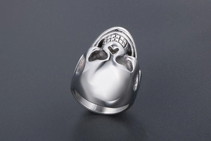 Detailed top view of polished silver skull ring with intricate facial structure