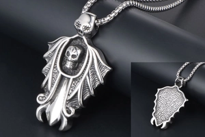 Close-up of gothic skull pendant with intricate wing textures and durable ball chain