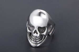 Macro detail of a polished punk skull ring for men made from shiny stainless steel