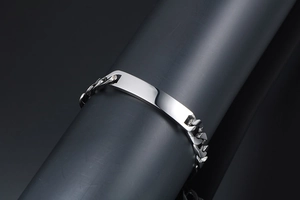Detailed view of silver Cuban link bracelet with a polished engravable ID rectangular plate
