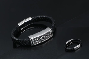 Macro detail of men's leather bracelet with star-engraved metal plate and magnetic clasp