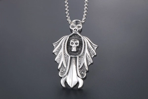 Detailed close-up of Gothic silver skull pendant with wings and box chain for men