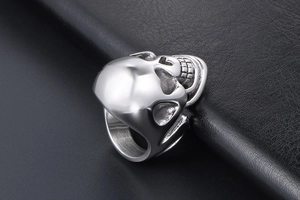 Detailed macro shot of vintage punk skull ring in polished stainless steel for men