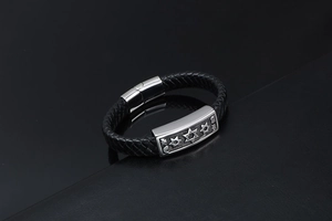 Detail of woven black leather strap and stainless steel clasp with engraved hexagram stars