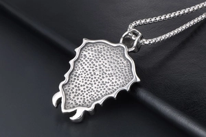 Macro view of punk skull sword pendant on box chain with textured shield details