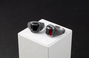 Gros plan de bagues rétro pour hommes avec pierres rectangulaires rouges et noires