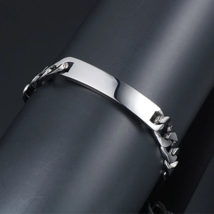 Polished titanium steel cuban link bracelet with silver ID plate for men on display