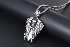 Macro shot of punk skeleton pendant with sword wings on a steel box chain