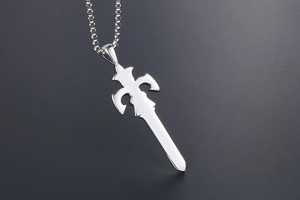 Close-up of a silver sword pendant with intricate hilt details on a bead chain necklace