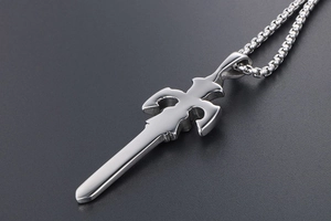 Macro detail of polished stainless steel sword pendant with a sleek box chain necklace