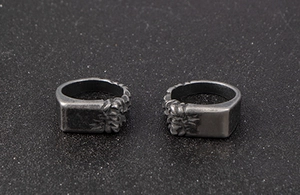 Macro shot of vintage silver-grey stainless steel rings with floral engraved textures