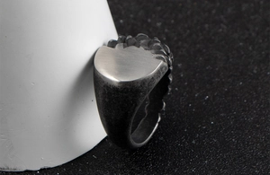 Macro view of vintage titanium steel ring with industrial texture and matte finish