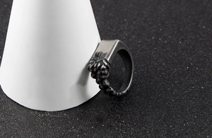 Detailed macro view of retro stainless steel men's ring with textured rock carving