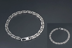 Close-up of geometric link chain bracelet with lobster clasp in polished titanium steel