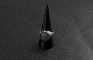 Detailed view of a vintage men's signet ring with crushed stone texture and polished steel