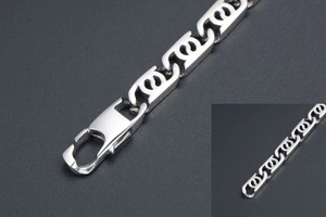 Macro detail of silver titanium steel S-link chain with a secure lobster clasp closure