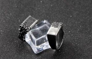 Close-up of vintage punk style men's stainless steel rings with rough textured metal details