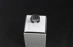 Close-up of vintage titanium steel square ring with cracked texture and geometric patterns