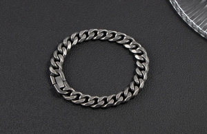 Detailed view of heavy polished stainless steel Cuban link bracelet with vintage clasp