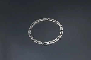 Macro detail of silver titanium steel curb chain with interlocking circle patterns