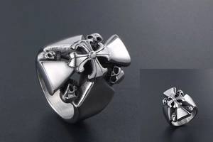 Macro detail of gothic titanium steel ring featuring skulls and central cross emblem