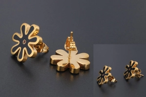 Detail of daisy stud earrings with black enamel petals and pink cubic zirconia
