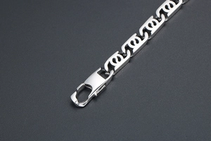 Close-up of silver flame-link titanium steel bracelet with a secure lobster clasp