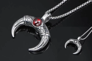 Macro detail of horn pendant with red gemstone inlay and vintage stainless steel textures