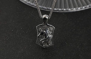 Close-up of vintage unicorn shield pendant with wheat chain in silver-toned steel