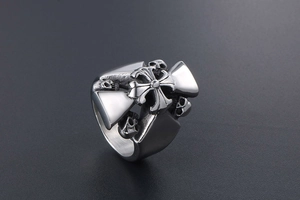 Detailed view of punk titanium steel ring with cross and skull head embossing