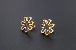 Detail view of daisy earrings with black enamel petals and a small pink center rhinestone