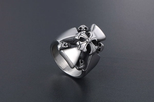 Detail of vintage steel ring featuring a gothic lily cross and skull engravings