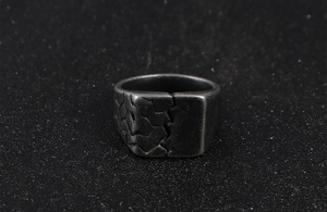 Macro shot of industrial vintage steel ring featuring asymmetric cracked geometric patterns