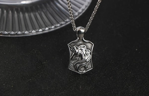 Detailed close-up of a vintage titanium steel unicorn shield pendant on a wheat chain