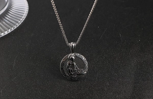 Macro detail of vintage Roman warrior pendant with Greek key pattern and braided steel chain