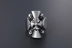Detail view of Gothic punk silver ring featuring central cross and skull engravings