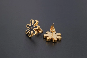 Detailed view of daisy flower stud earrings with black petals and red center stone
